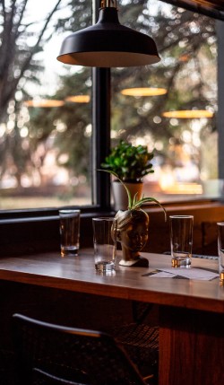 A table with glasses near the window